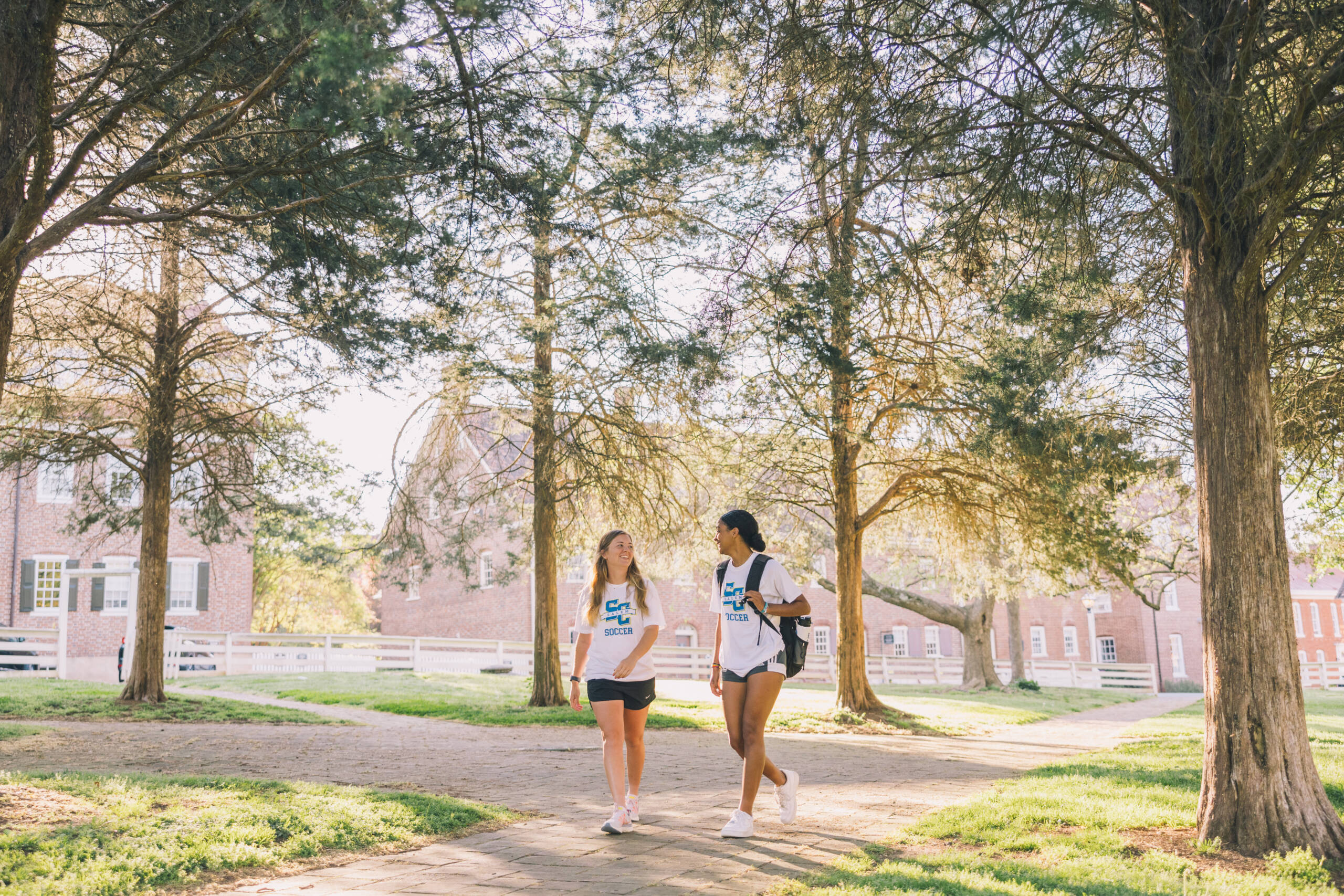 Salem College Soccer players walking down campus path